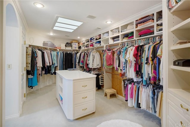 walk in closet featuring light colored carpet