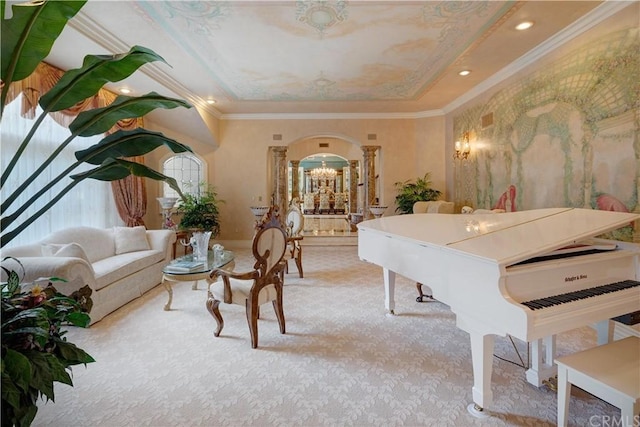 rec room with light carpet, an inviting chandelier, crown molding, and ornate columns