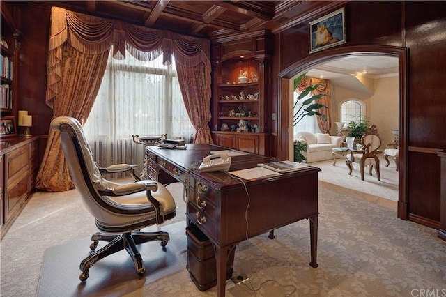 office area with coffered ceiling, beam ceiling, ornamental molding, light carpet, and built in features