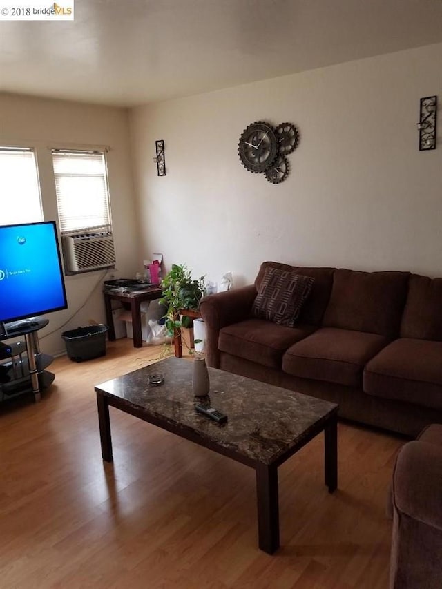 living room featuring cooling unit and hardwood / wood-style flooring