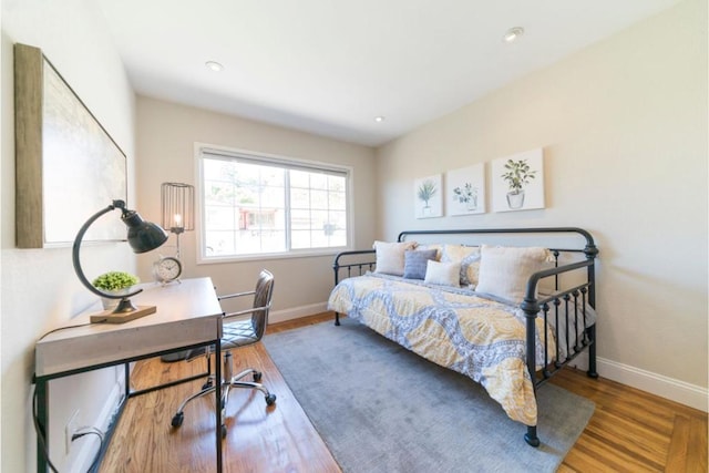 bedroom with hardwood / wood-style flooring