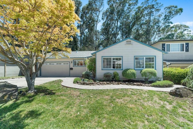 view of front of home with a front lawn and a garage