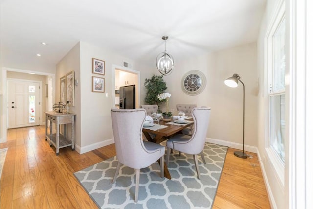 dining room featuring hardwood / wood-style floors and a chandelier