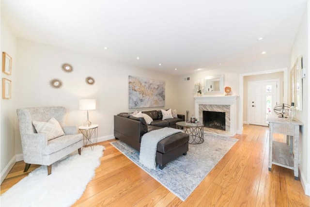 living room with a fireplace and light hardwood / wood-style flooring