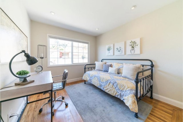 bedroom with hardwood / wood-style floors