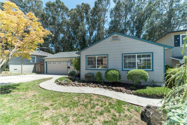 ranch-style home featuring a front yard and a garage