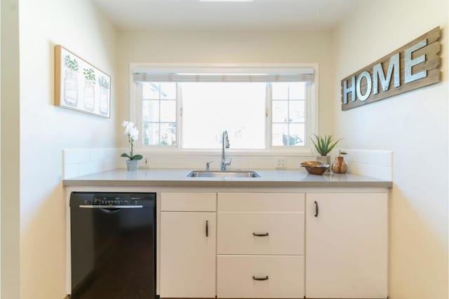 kitchen featuring white cabinets, dishwasher, and sink