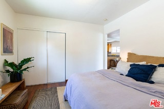 bedroom featuring hardwood / wood-style floors and a closet