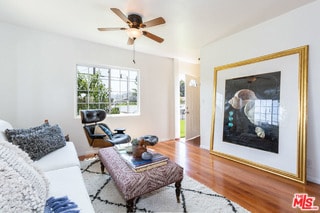 living room featuring ceiling fan and light hardwood / wood-style flooring