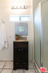 bathroom with vanity, tile patterned flooring, and an enclosed shower