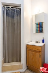 bathroom with a shower with curtain and vanity