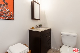 bathroom with tile patterned floors, vanity, and toilet