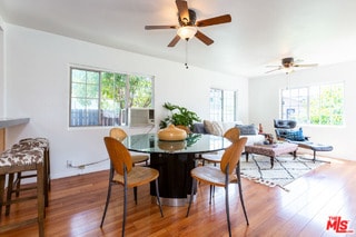 dining space with ceiling fan and hardwood / wood-style flooring