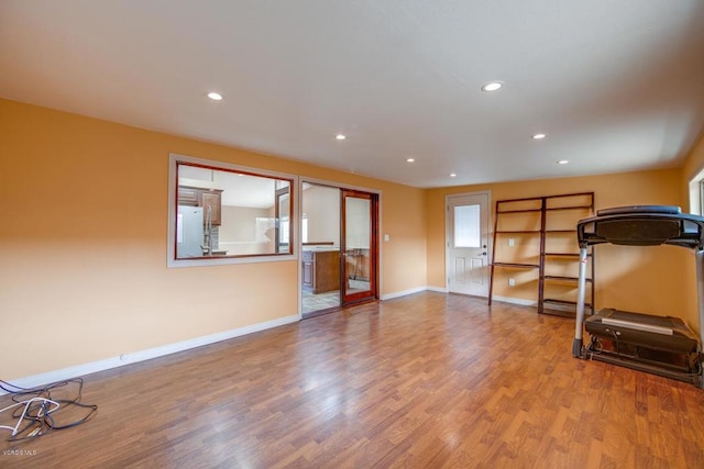 workout room with light hardwood / wood-style floors