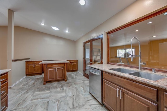 kitchen with light tile patterned flooring, dishwasher, light stone counters, a center island, and sink