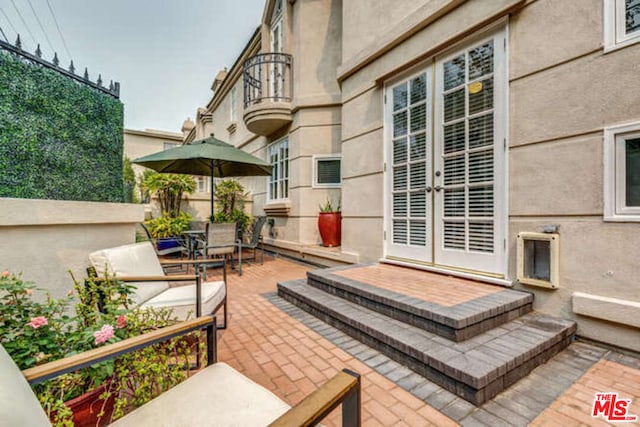 view of patio featuring french doors and a balcony