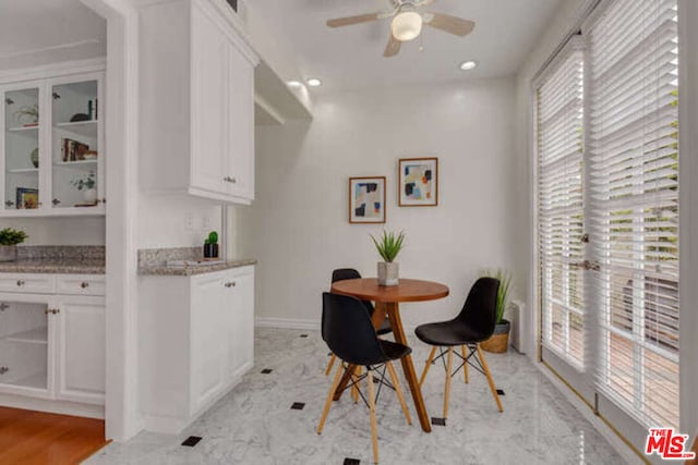 dining room with ceiling fan and light wood-type flooring