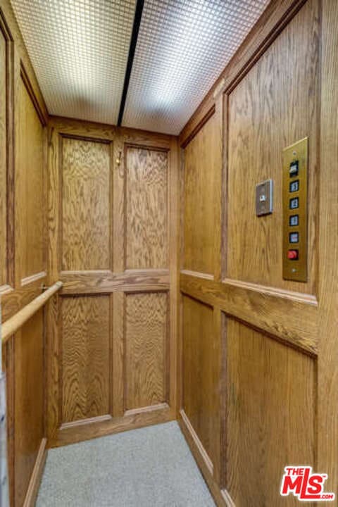 interior details featuring elevator and wooden walls