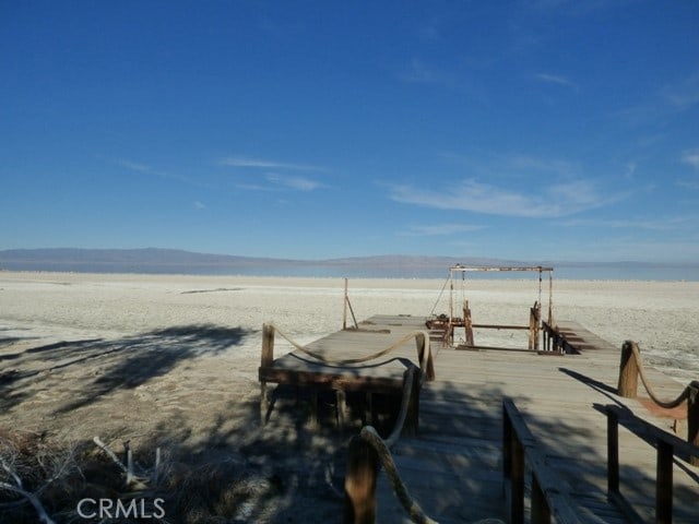 view of home's community with a water view and a dock