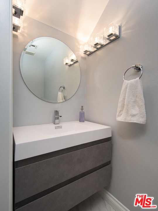 bathroom with vanity and vaulted ceiling