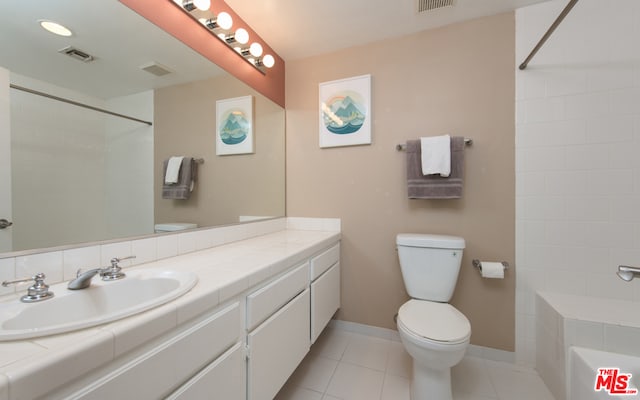 bathroom with tile patterned floors, vanity, and toilet