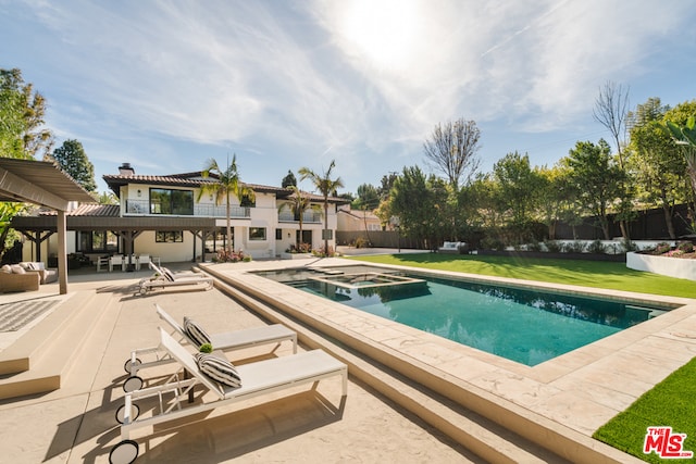 view of pool featuring a patio, an in ground hot tub, and a lawn