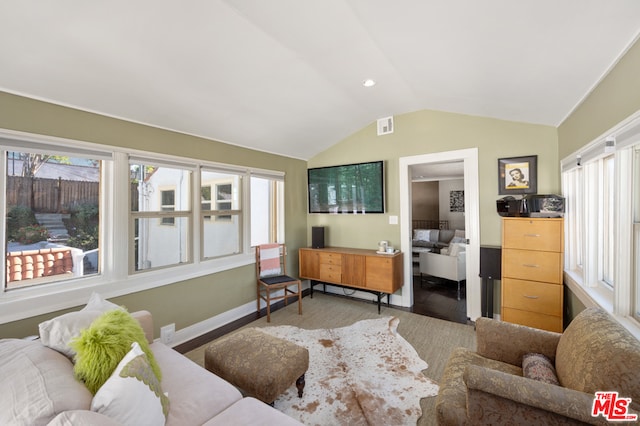 living room with hardwood / wood-style floors and lofted ceiling