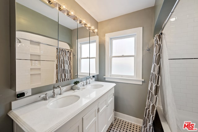 bathroom featuring double sink vanity, shower / bath combination with curtain, and tile floors