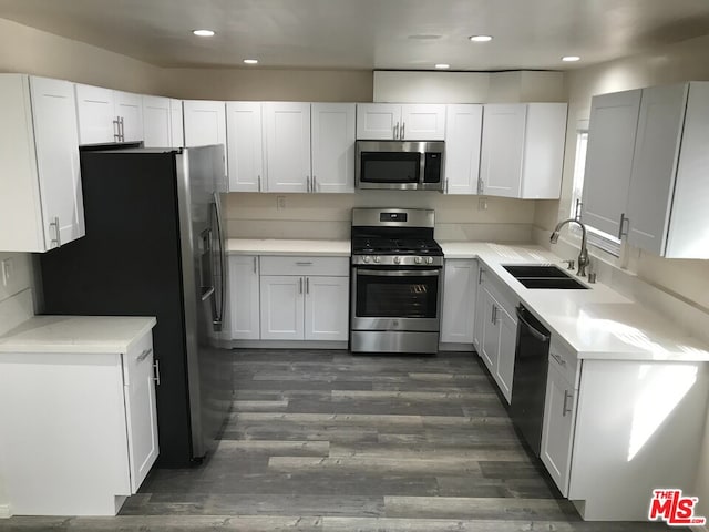 kitchen with white cabinets, stainless steel appliances, and sink