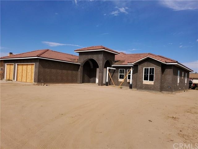 rear view of property with a garage