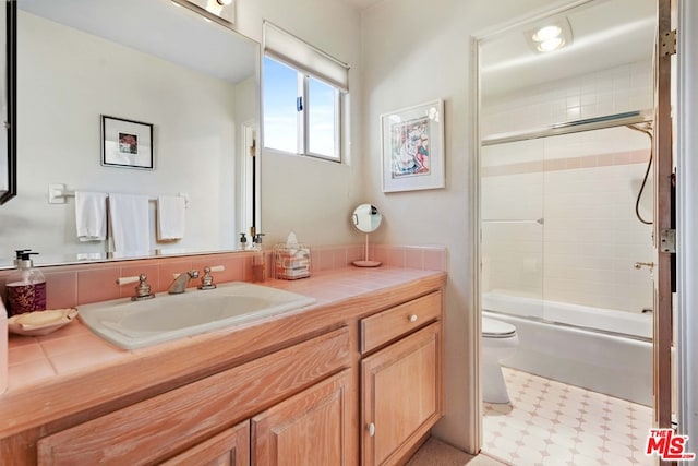 full bathroom with tile patterned floors, vanity, toilet, and enclosed tub / shower combo