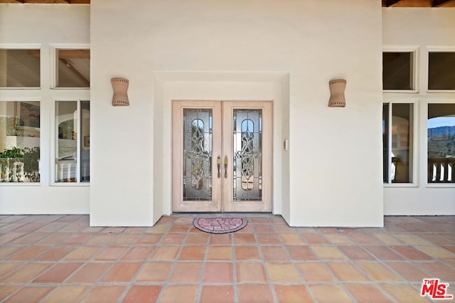 entrance to property featuring french doors