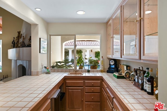 bar with tile counters and plenty of natural light