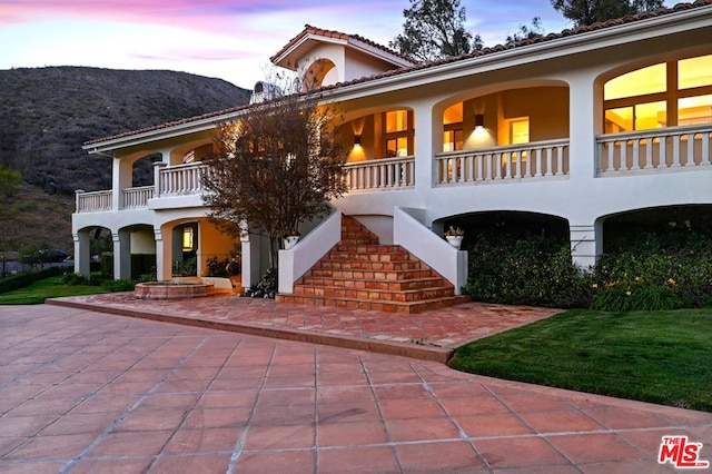 view of front facade with a balcony and a mountain view