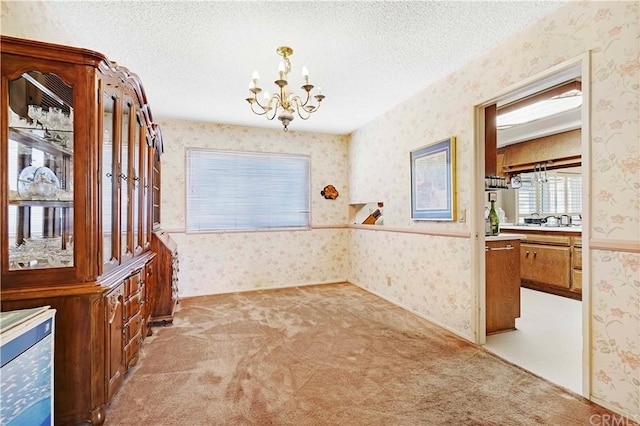 interior space with a textured ceiling and a chandelier