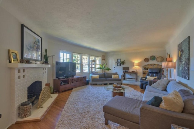 living room featuring hardwood / wood-style floors and a brick fireplace