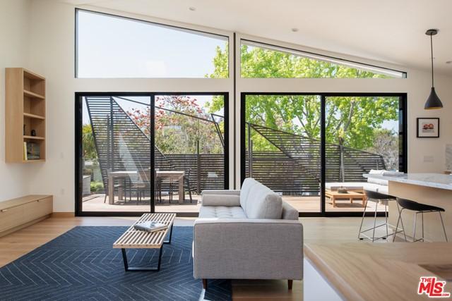 living room with lofted ceiling, plenty of natural light, and light hardwood / wood-style floors