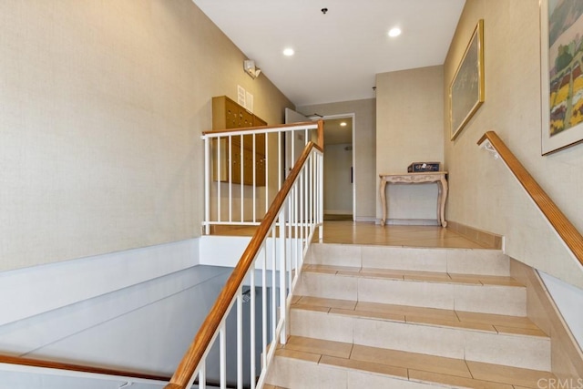 staircase featuring tile patterned flooring