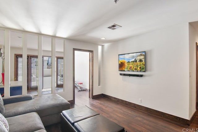 living room with dark wood-type flooring and french doors