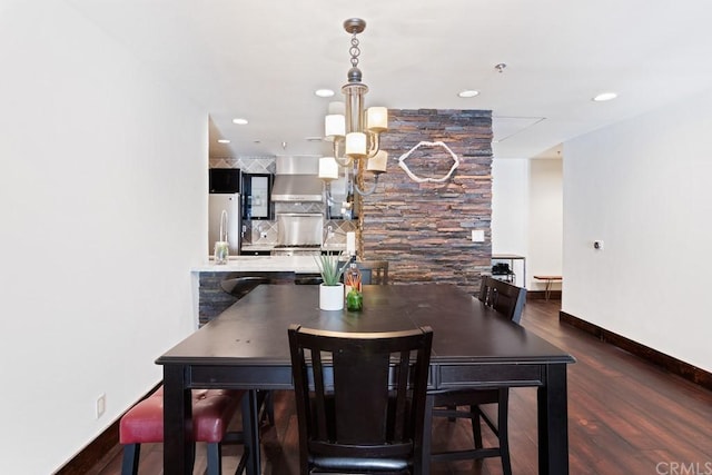 dining space with dark hardwood / wood-style flooring