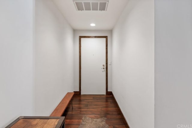 hallway with dark hardwood / wood-style flooring