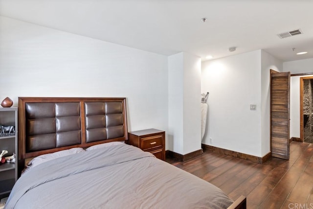 bedroom with dark wood-type flooring