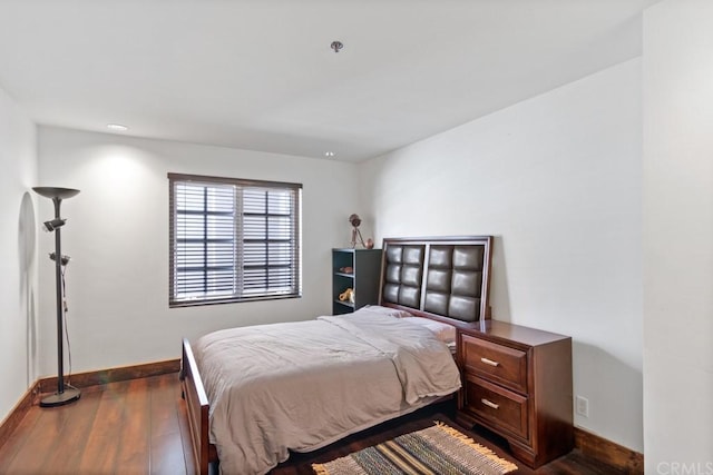 bedroom with dark wood-type flooring