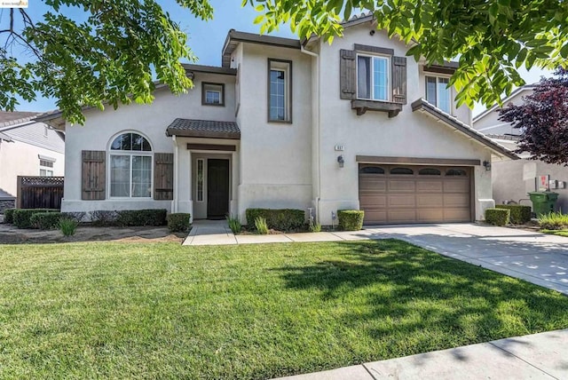 view of front of house featuring a front lawn and a garage