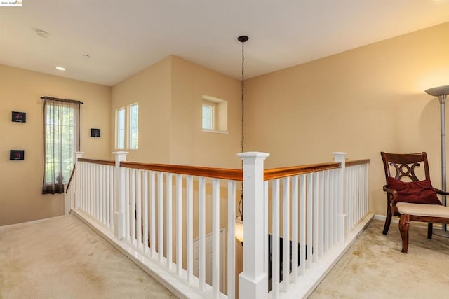 corridor with light colored carpet