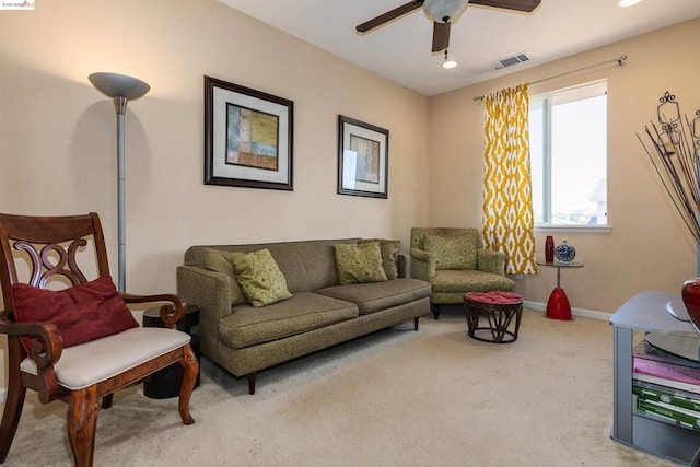 living room with ceiling fan and light colored carpet