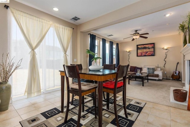 carpeted dining area featuring ceiling fan