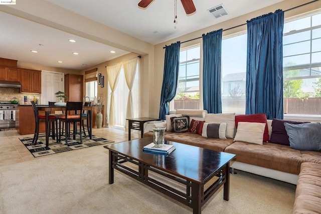 living room featuring ceiling fan and light colored carpet