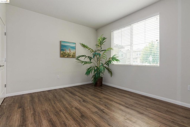 unfurnished room featuring dark hardwood / wood-style flooring