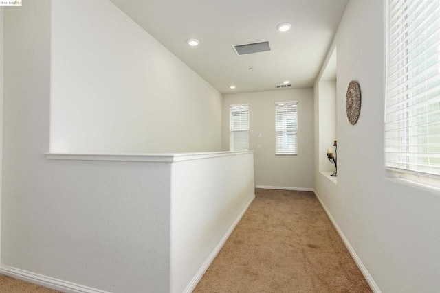 corridor with light colored carpet